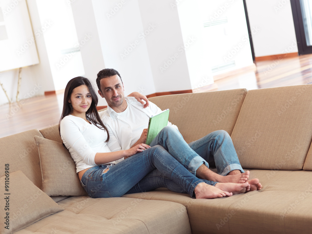 couple at modern home using tablet computer