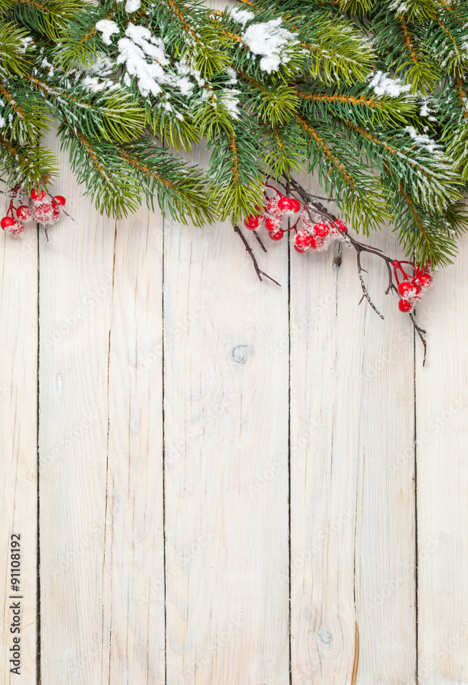 Christmas wooden background with fir tree and holly berry Christmas wooden background with fir tree and holly berry