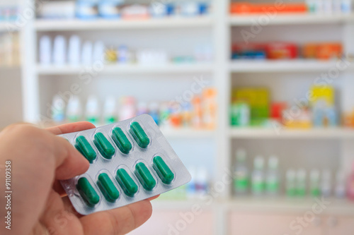 Close up of pharmacist hands holding medicine pills