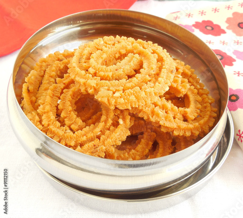 Murukku, also known as chakli, is a traditional and popular Indian snack. photo