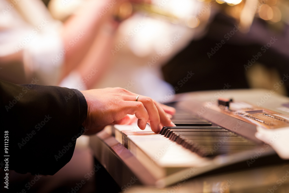 Human hand playing the synth at the concert