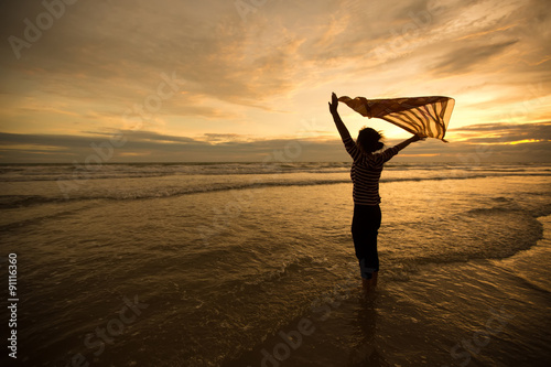 Beautiful Girl With  Scarf on The Beach enjoying summer.