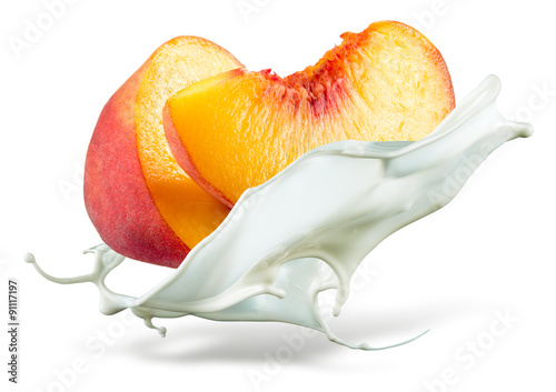 Peach is falling into milk. Splash isolated on white background