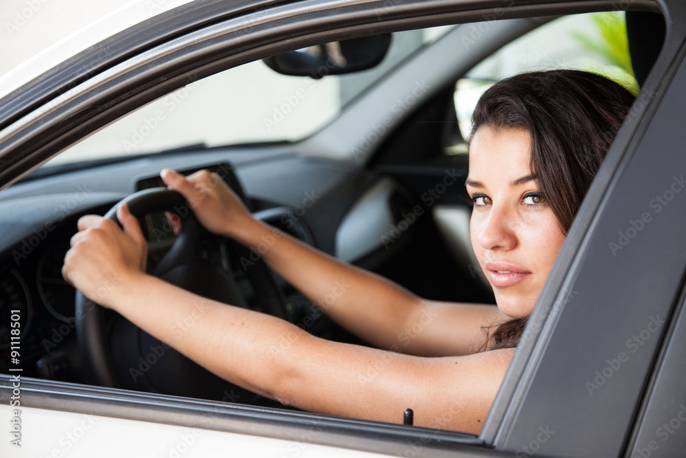 Female brunette driving with both hand on wheel