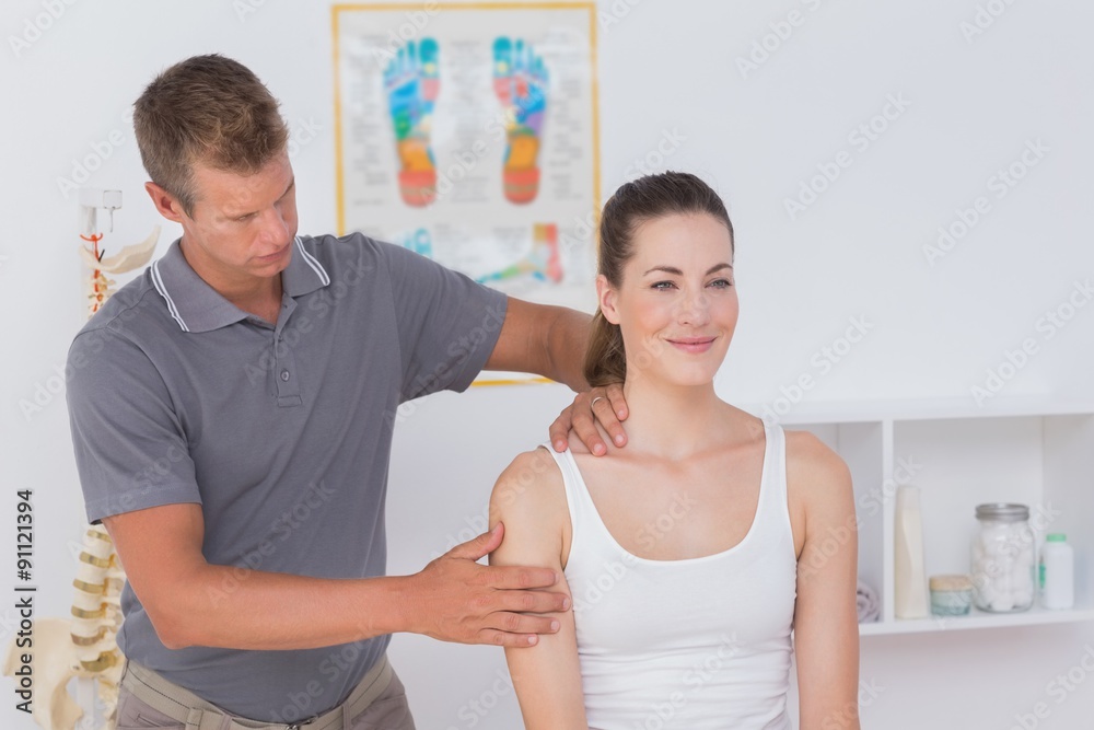 Fototapeta premium Doctor stretching woman arm