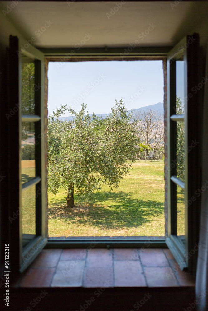 View of the countryside of Tuscany through a window View of the countryside of Tuscany through a window