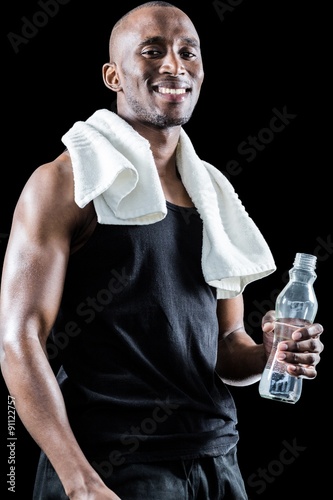 Portrait of happy muscular man with towel around neck 