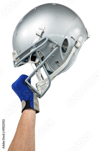 Cropped image of American football player handing his helmet