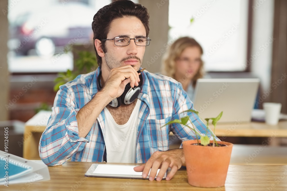 Thoughtful man with hand on chin sitting in office Thoughtful man with hand on chin sitting in office