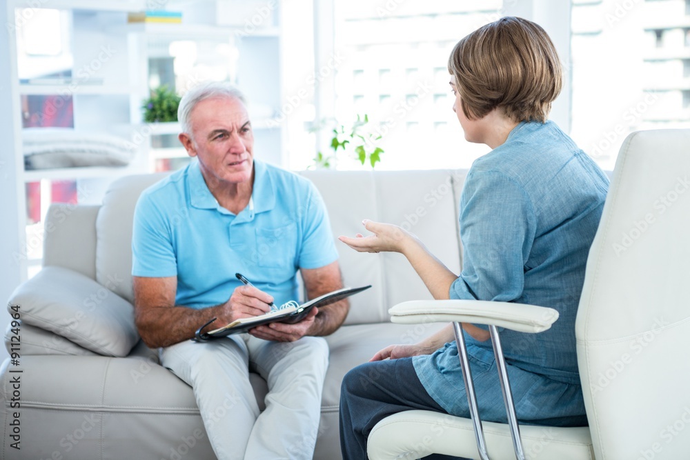 Doctor discussing with patient at home Doctor discussing with patient at home