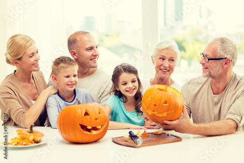 happy family sitting with pumpkins at home