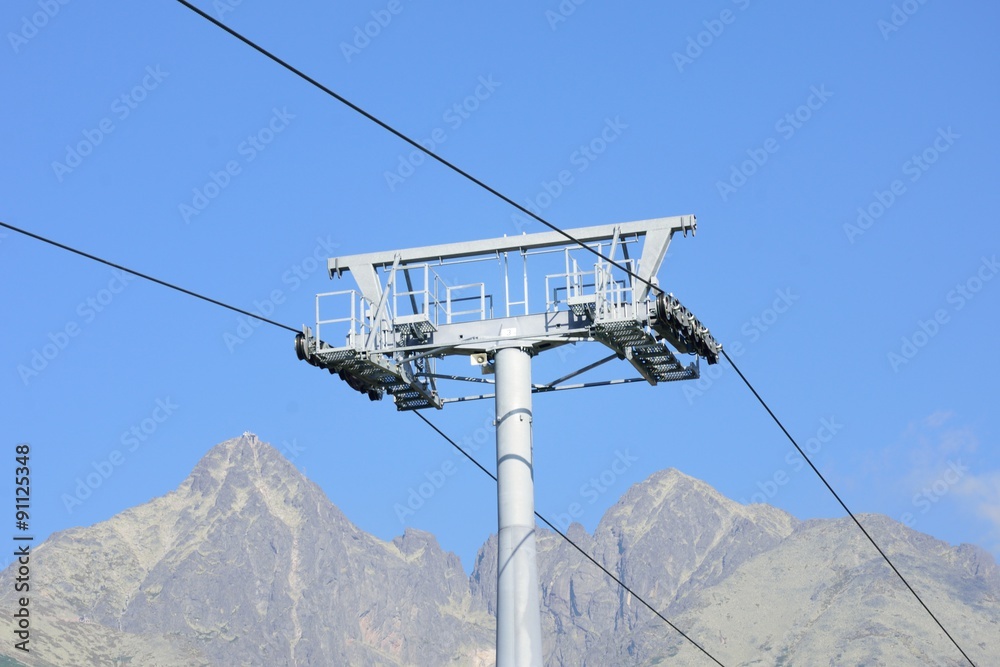 Chair lift mechanism with mountain in background Chair lift mechanism with mountain in background