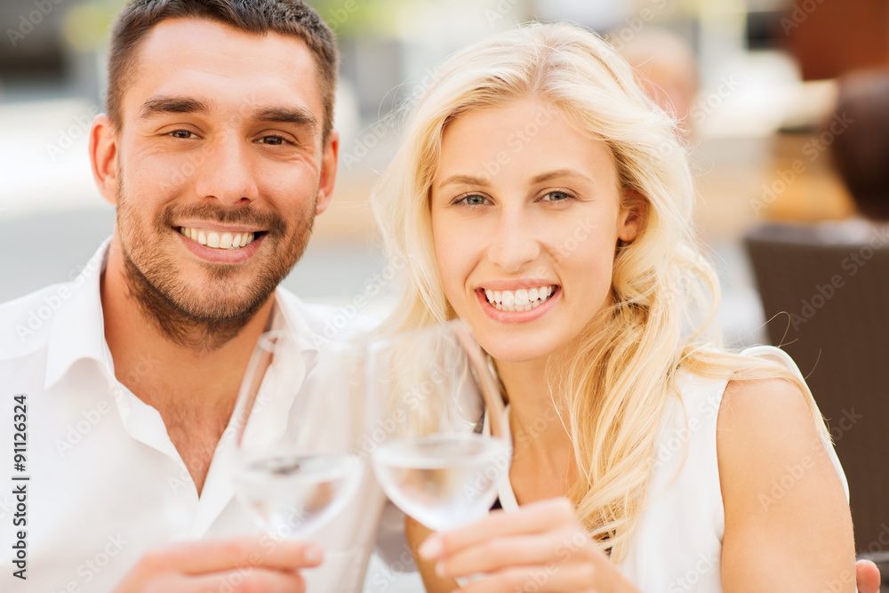 happy couple clinking glasses at restaurant lounge happy couple clinking glasses at restaurant lounge