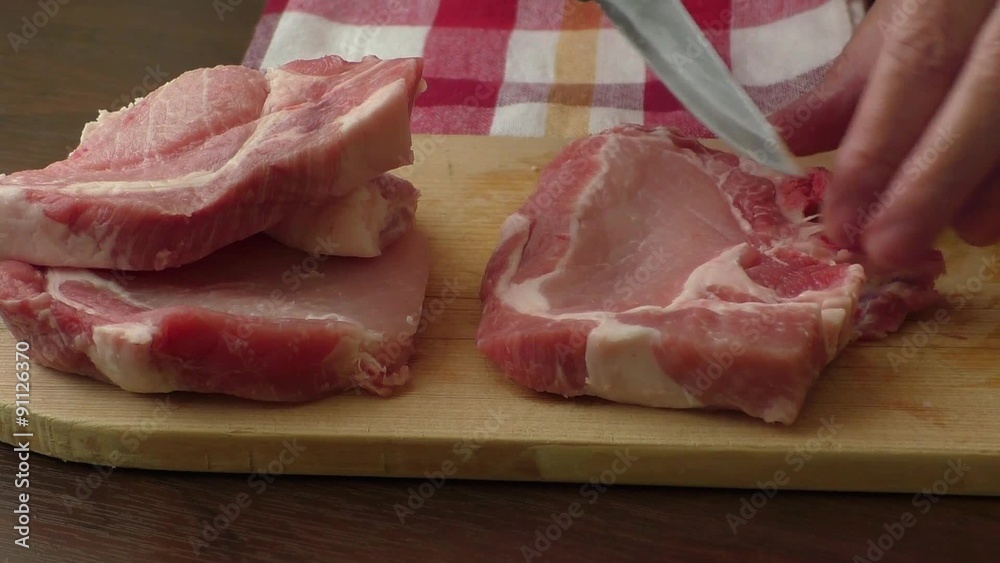 Raw pork chop steak on wooden background
Raw pork chop steak on wooden background