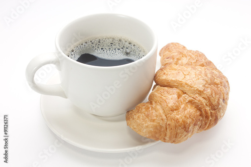 Coffee cup with a croissant isolated