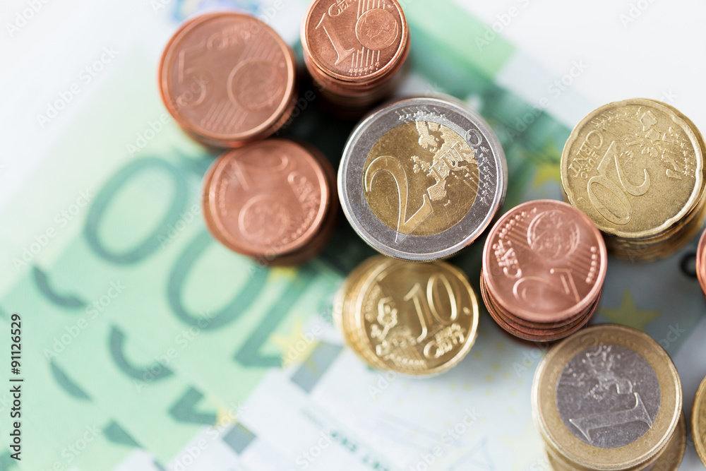 close up of euro paper money and coins on table close up of euro paper money and coins on table
