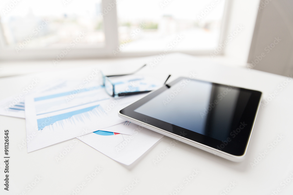 close up of tablet pc, glasses and files in office close up of tablet pc, glasses and files in office