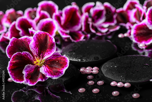beautiful composition of geranium flower  beads and black zen st