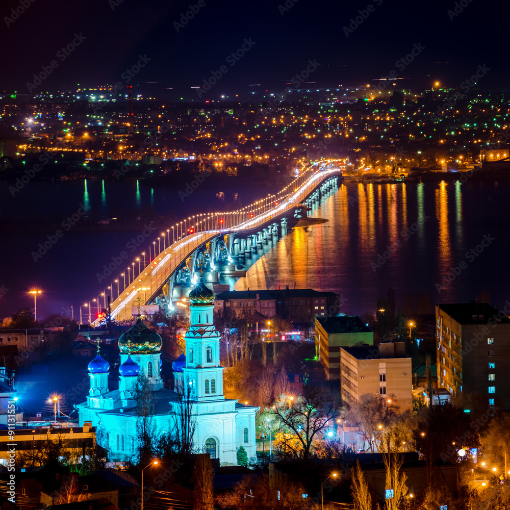 beautiful landscape of evening city Saratov with church and brid