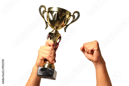 Gold cup in hands isolated on white