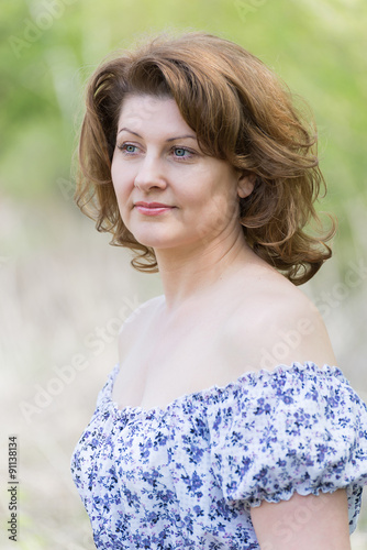  middle-aged woman in the summer park