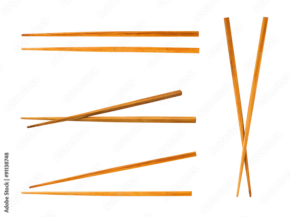 Wooden pairs of chopsticks on white background Wooden pairs of chopsticks on white background