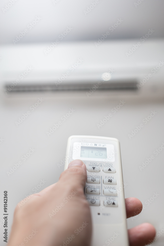 hand with remote control air conditioner blur background hand with remote control air conditioner blur background