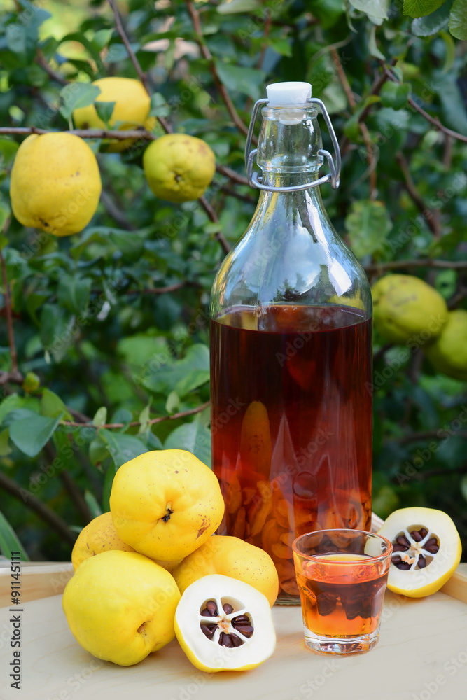 Tincture of quince and fruit on a wooden table. Tincture of quince and fruit on a wooden table.