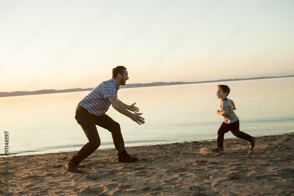 Fototapeta premium Father with is son at the sunset