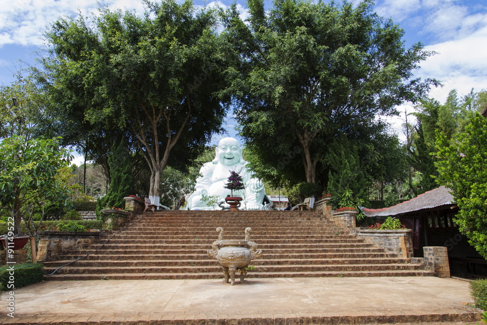Statue of sitting and smiling Buddha