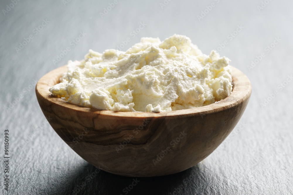 creamy cheese in wooden bowl creamy cheese in wooden bowl