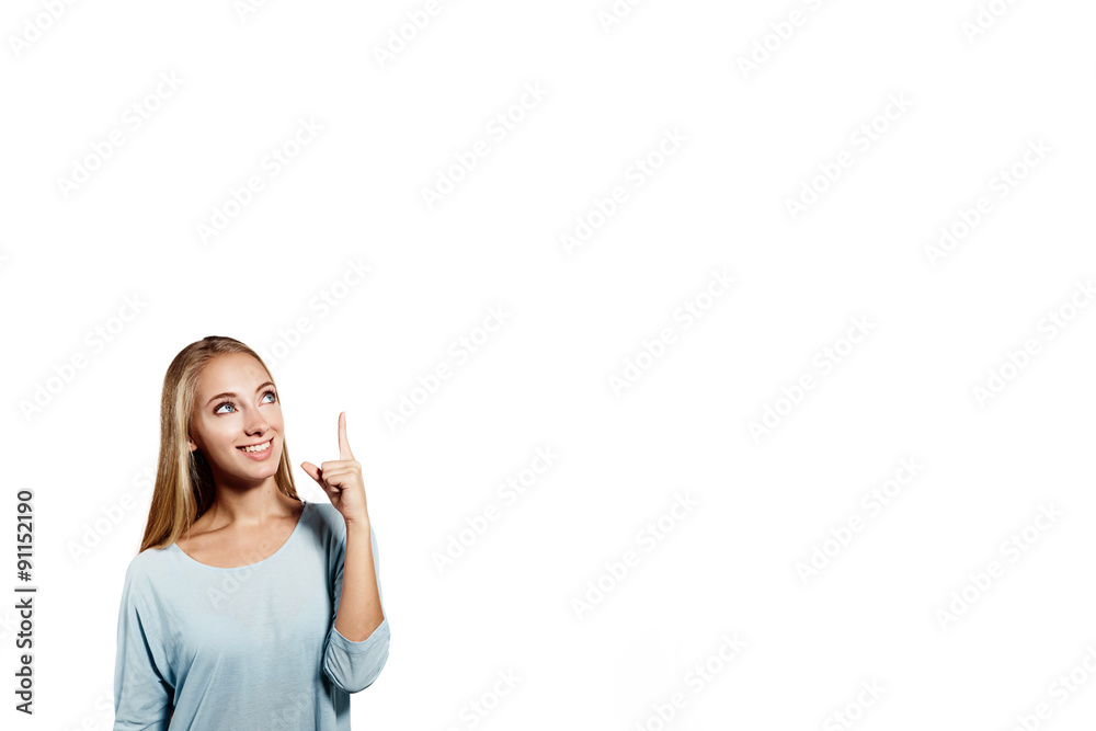 Woman smiling pointing up showing copy space. Closeup of beautiful young professional businesswoman isolated on white background. Woman smiling pointing up showing copy space. Closeup of beautiful young professional businesswoman isolated on white background.