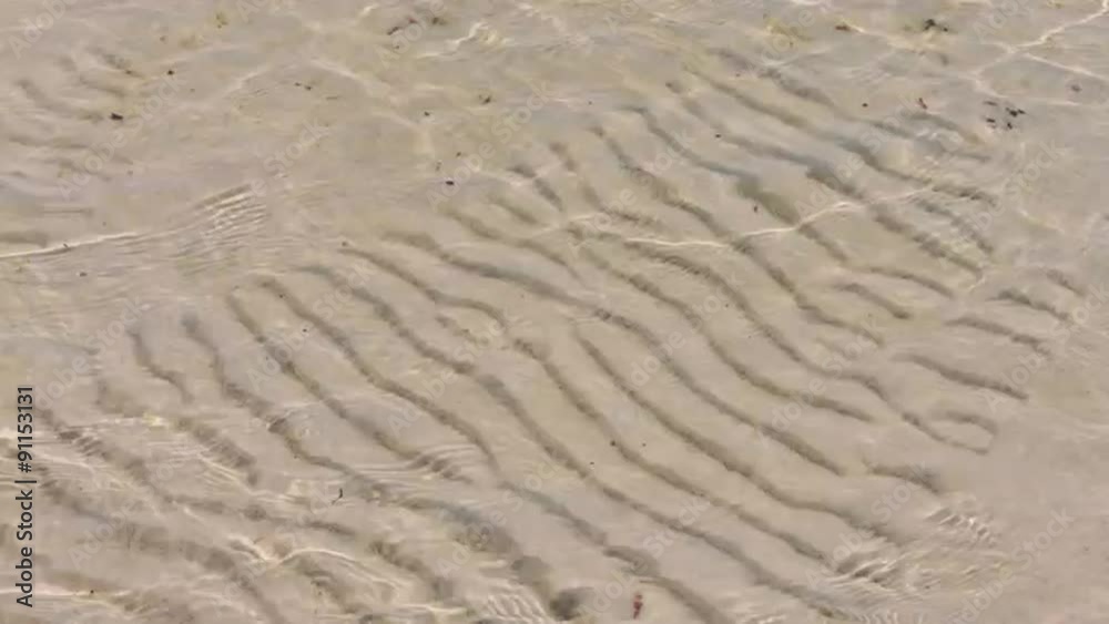 Transparent water ripple, sand waves and sunlight glare. sea Transparent water ripple, sand waves and sunlight glare. sea