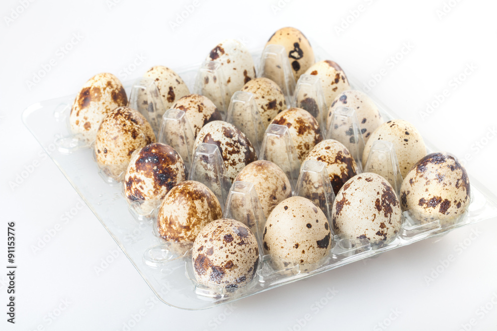 Quail eggs in a transparent plastic container