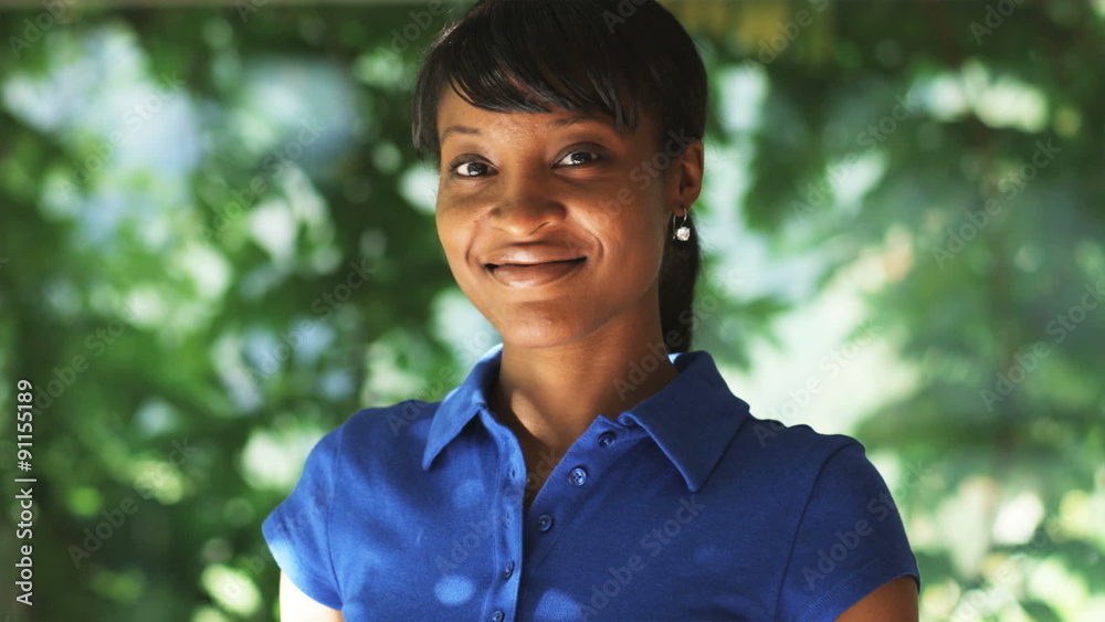 woman in a blue polo shirt looking at camera woman in a blue polo shirt looking at camera