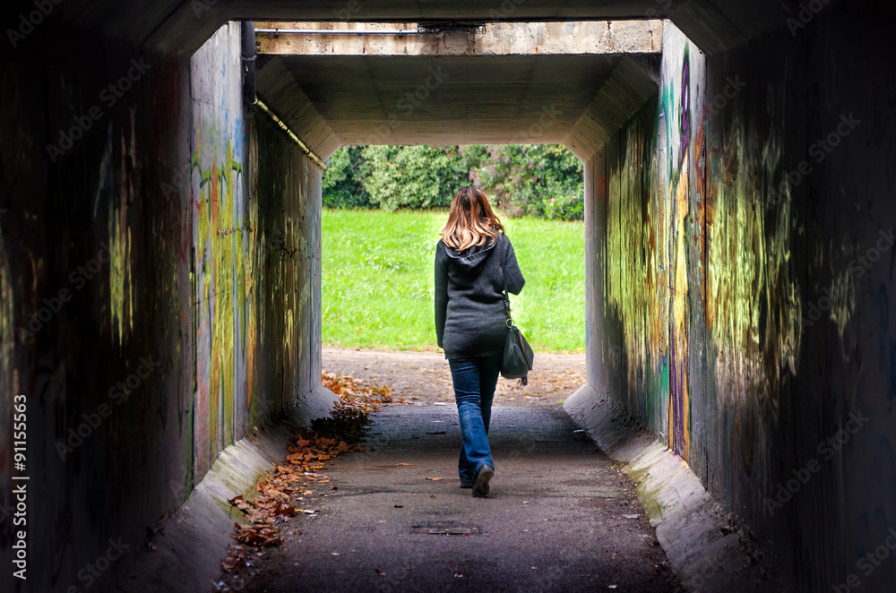 woman tunnel walk alone dark underspass