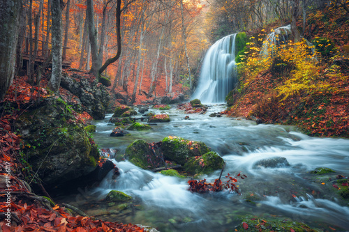 Fototapeta Naklejka Na Ścianę i Meble -  Beautiful waterfall in autumn forest in crimean mountains at sun