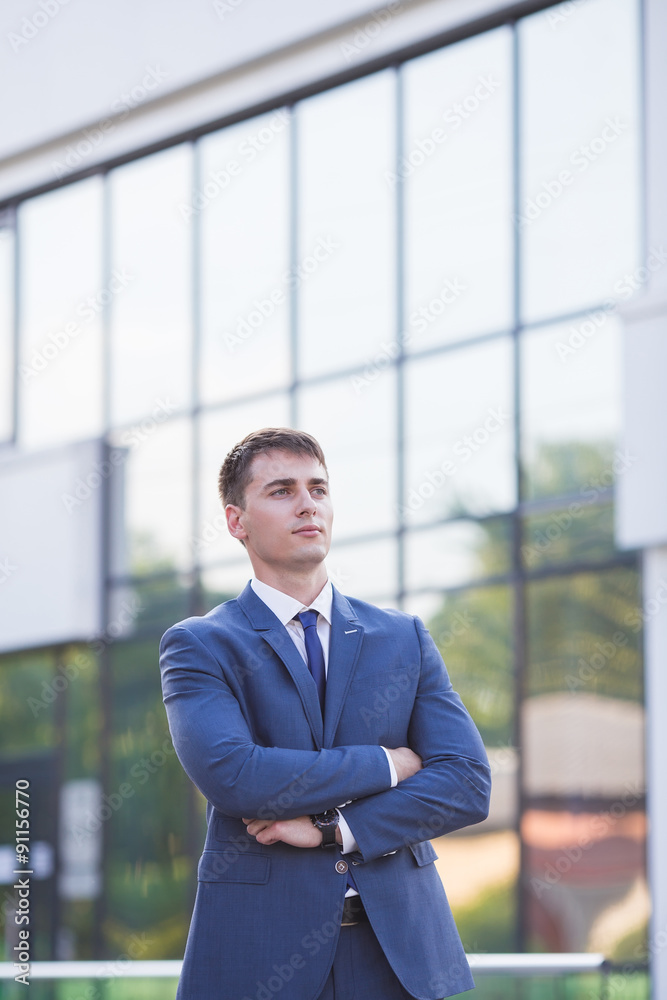 Portrait of a young businessman standing over blurred background Portrait of a young businessman standing over blurred background