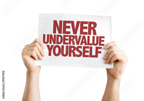 Never Undervalue Yourself placard isolated on white photo