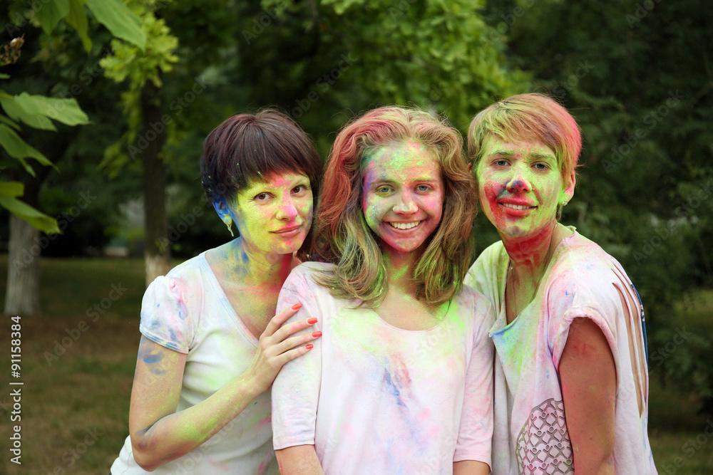 Young people celebrate Holi color festival in park Young people celebrate Holi color festival in park