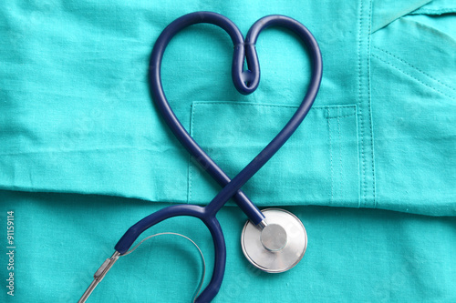A stethoscope shaping a heart and a clipboard on a medical