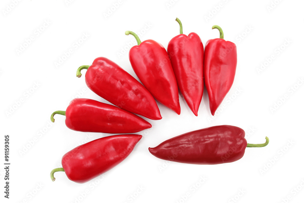 seven bright red sweet peppers on a white background seven bright red sweet peppers on a white background