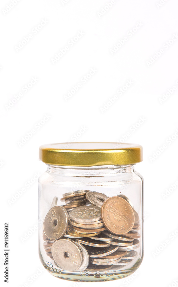 Japanese Yen coins in a mason jar over white background Japanese Yen coins in a mason jar over white background