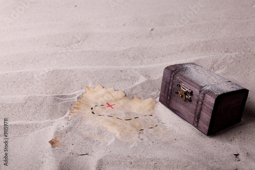 An old chest and a treasure map found in the sand