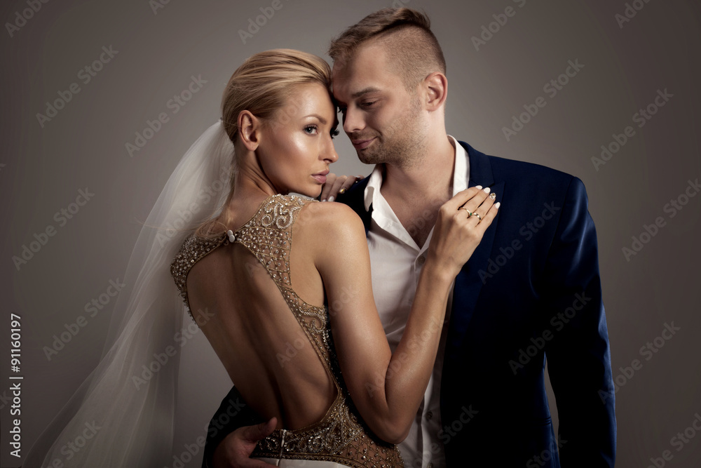 Beautiful wedding couple posing in studio. Beautiful wedding couple posing in studio.