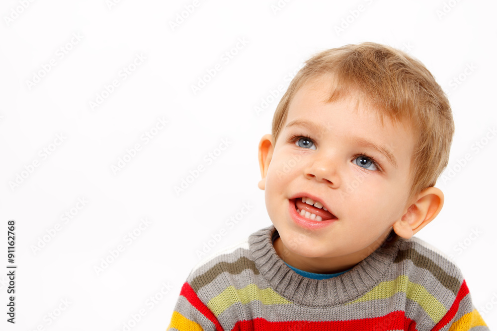 Face of happy boy in winter clothes looking up Face of happy boy in winter clothes looking up