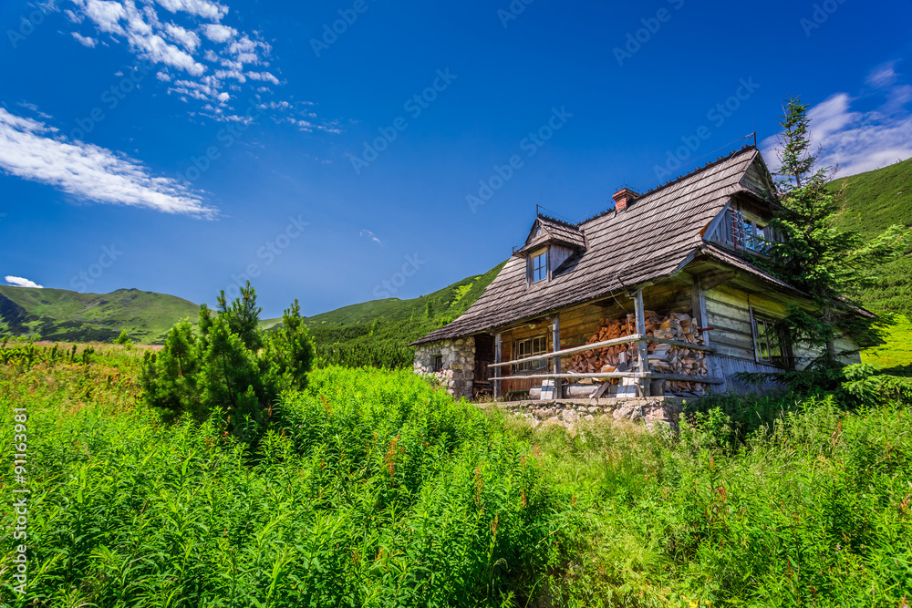 Small cottage in a mountain valley at sunrise