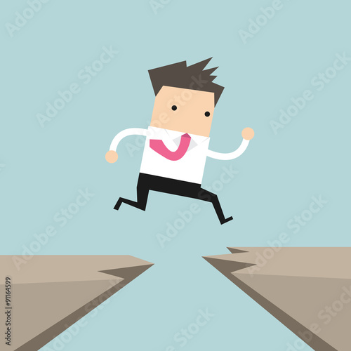 Businessman jump through the gap from one cliff to another