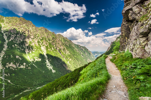 Mountains trail leading the peak at summer