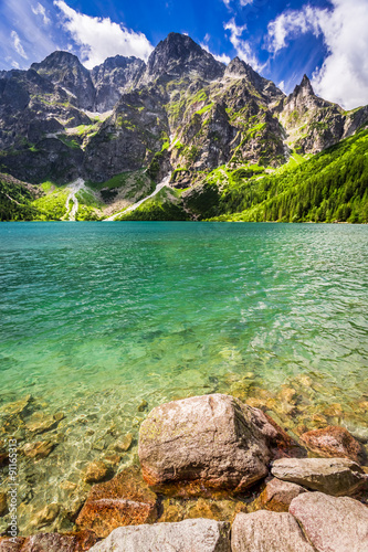 Fototapeta Naklejka Na Ścianę i Meble -  Pond in the middle of the mountains at dawn